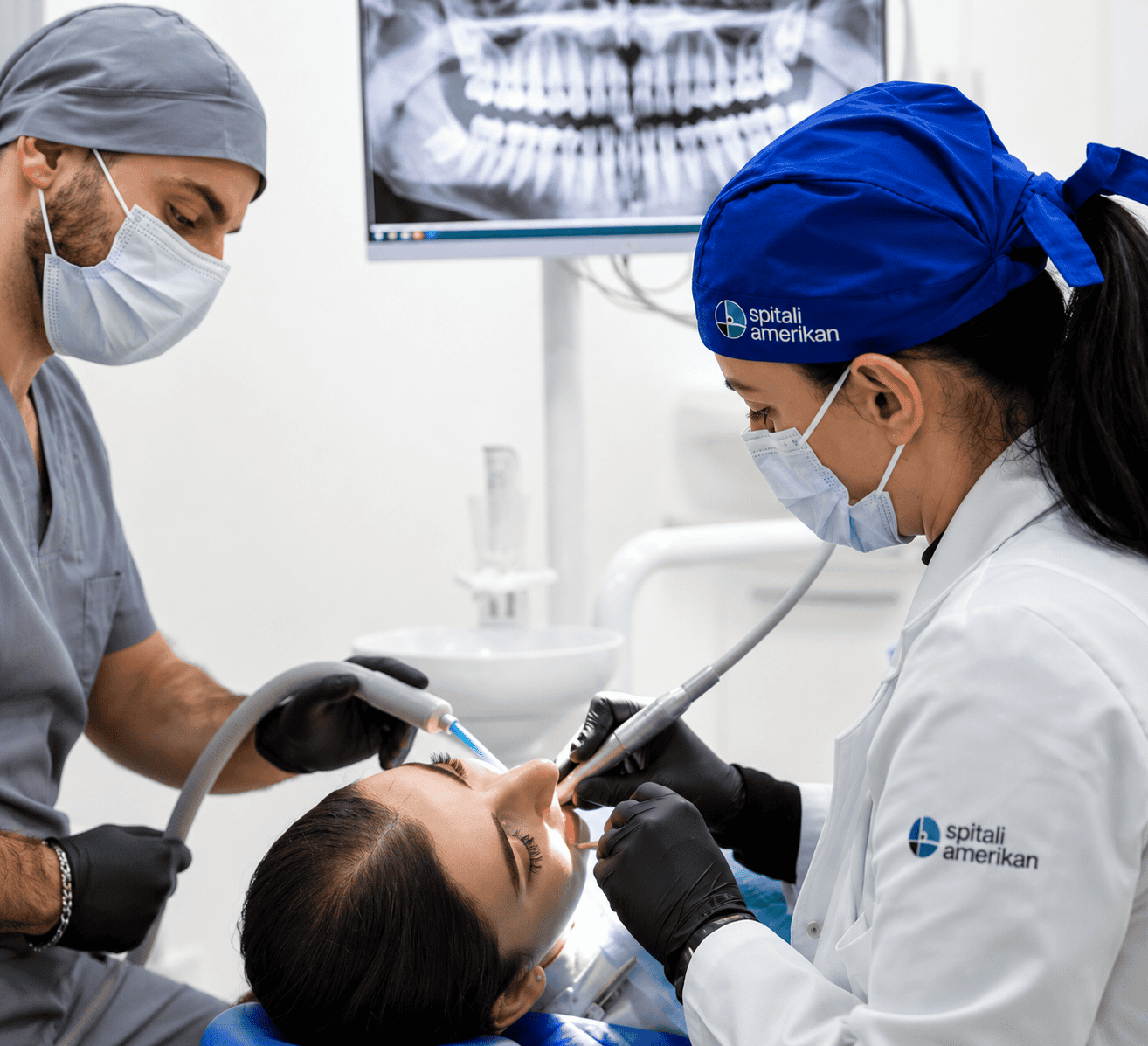 Dental professionals performing a dental procedure on a patient in a clinical setting.