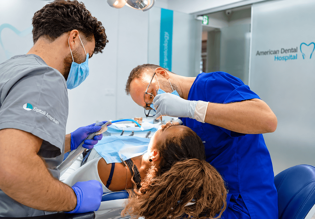 Dentists performing a dental procedure on a patient at American Dental Hospital.