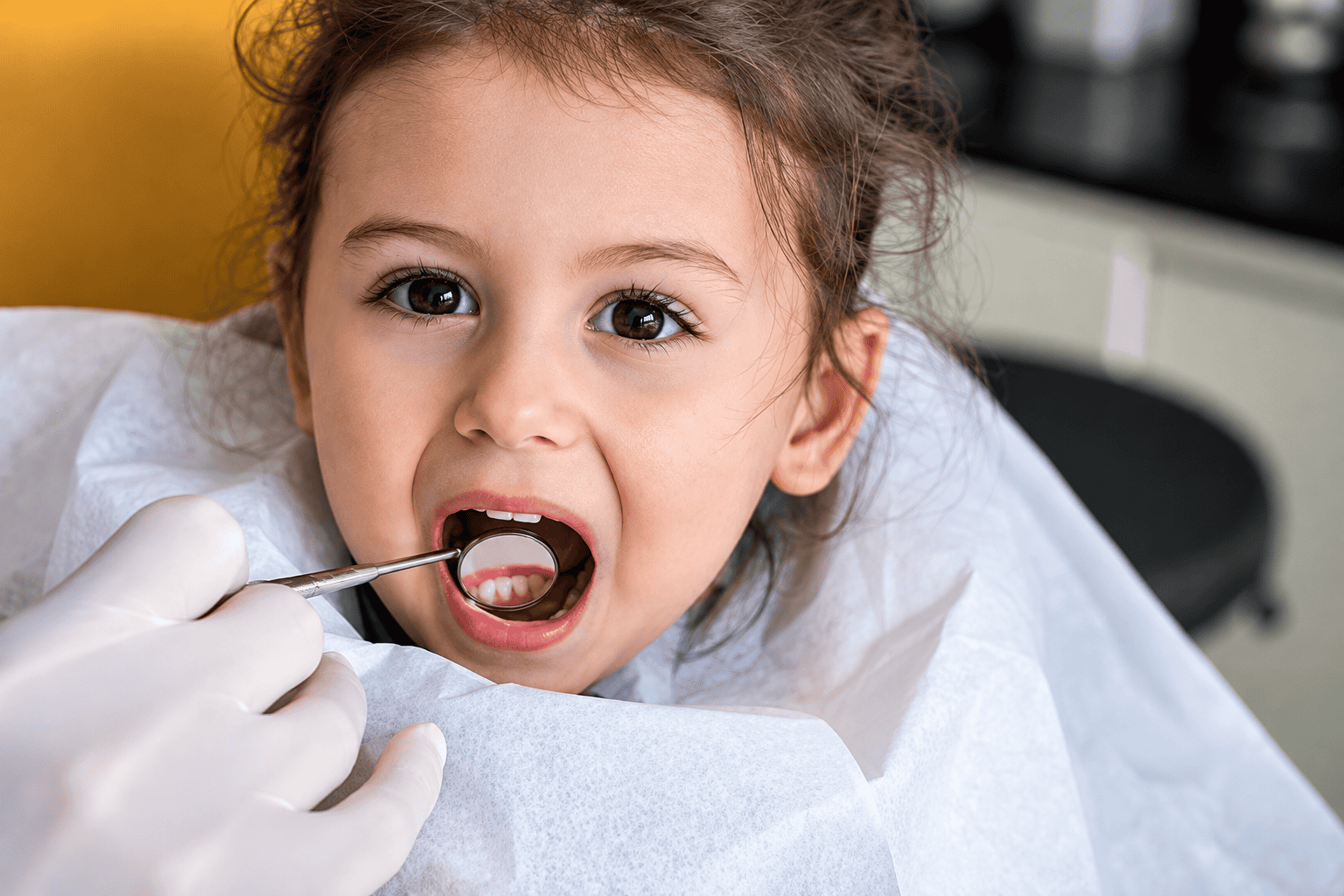 Child at the dentist during a dental check-up and cleaning.