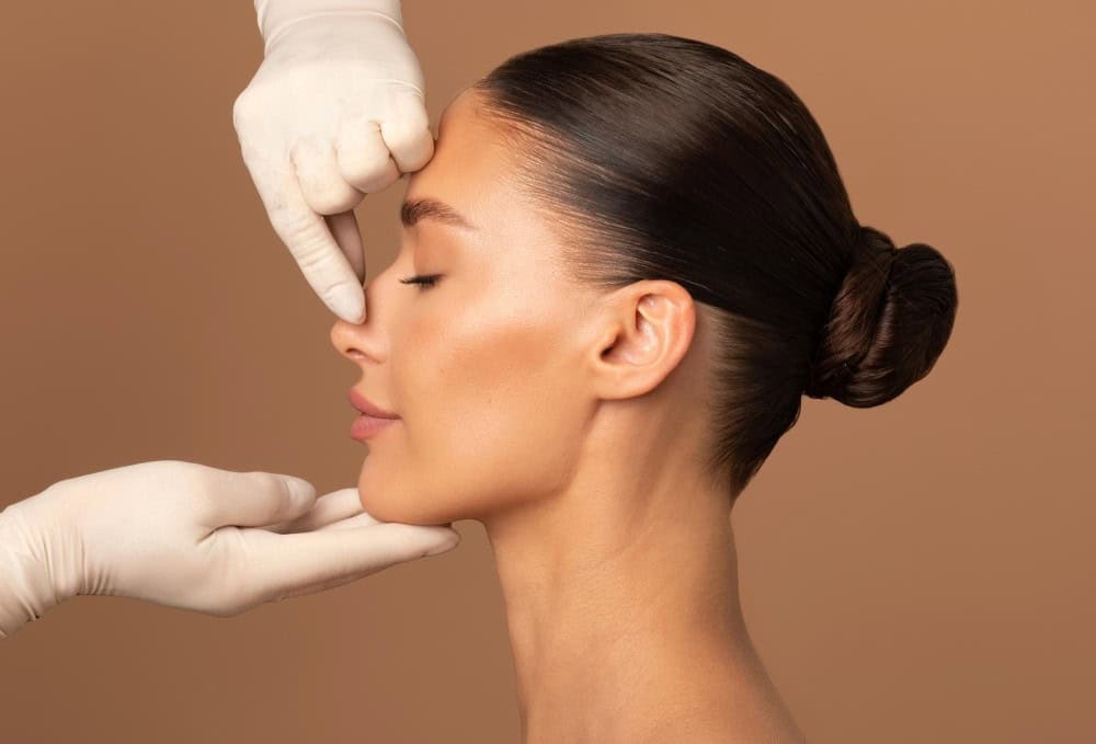 Woman receiving a cosmetic consultation, close-up of face and professional hands.