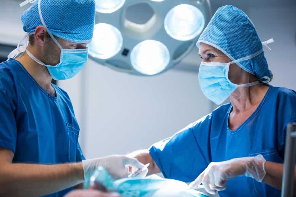 Skilled surgeons performing plastic surgery in Albania operating room.