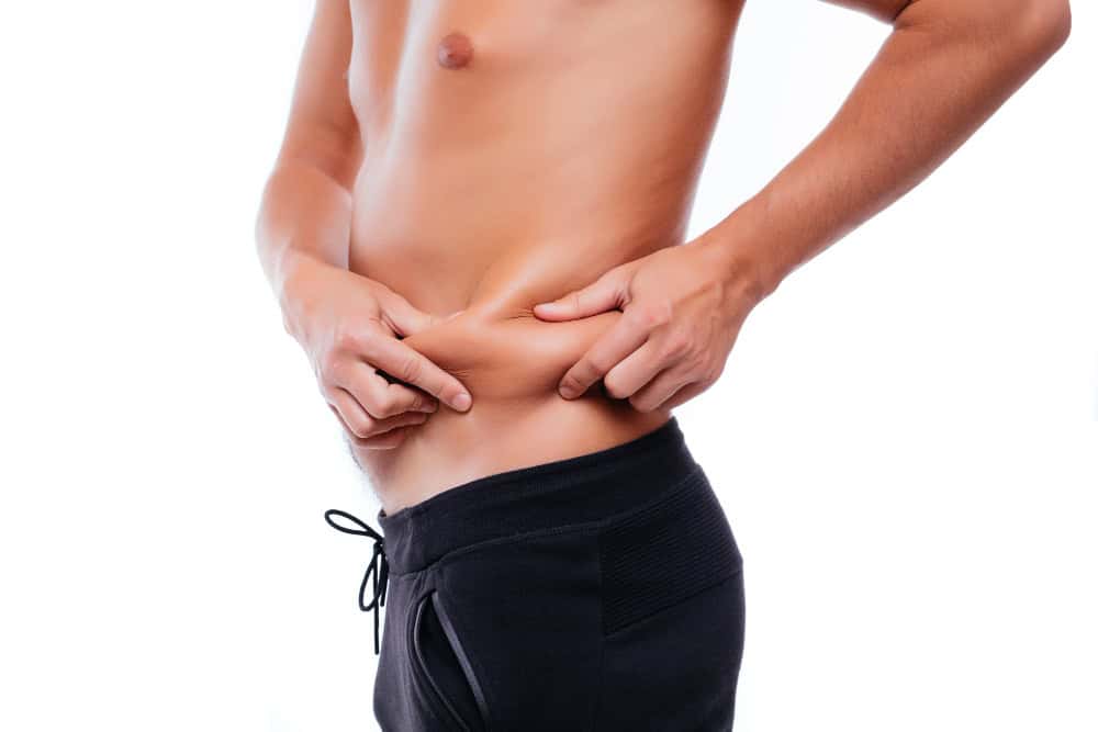Man pinching abdominal fat, showing liposuction treatment areas.